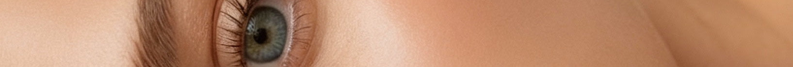 Close-up of a person's eye with detailed eyelashes and skin texture.